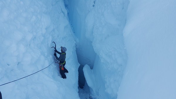 Sid ice climbing in a crevasse during a 10-day custom mountaineering course.