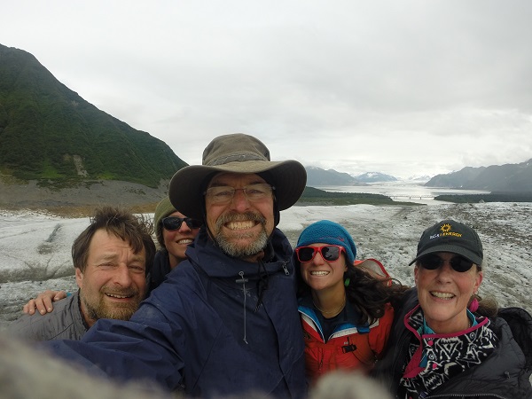 Leslie, Sarah, Sue, Pat, and Gary squeezing together for a picture as they hike on the Child's Glacier on a Copper River rafting trip!