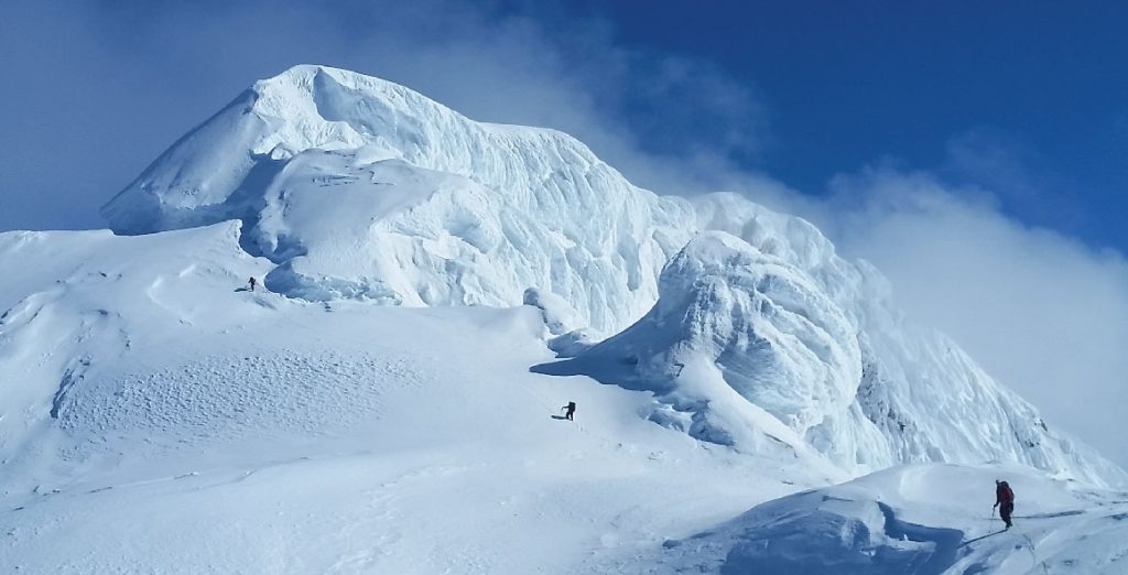 Climbers approach the snowy rime mushrooms on Mt. Drum