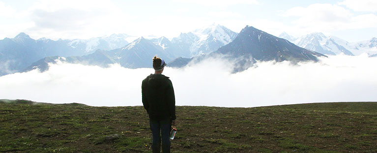 Person standing above the clouds