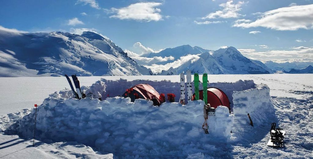 Skis and tent in snowy basecamp in the Chugach Mountains