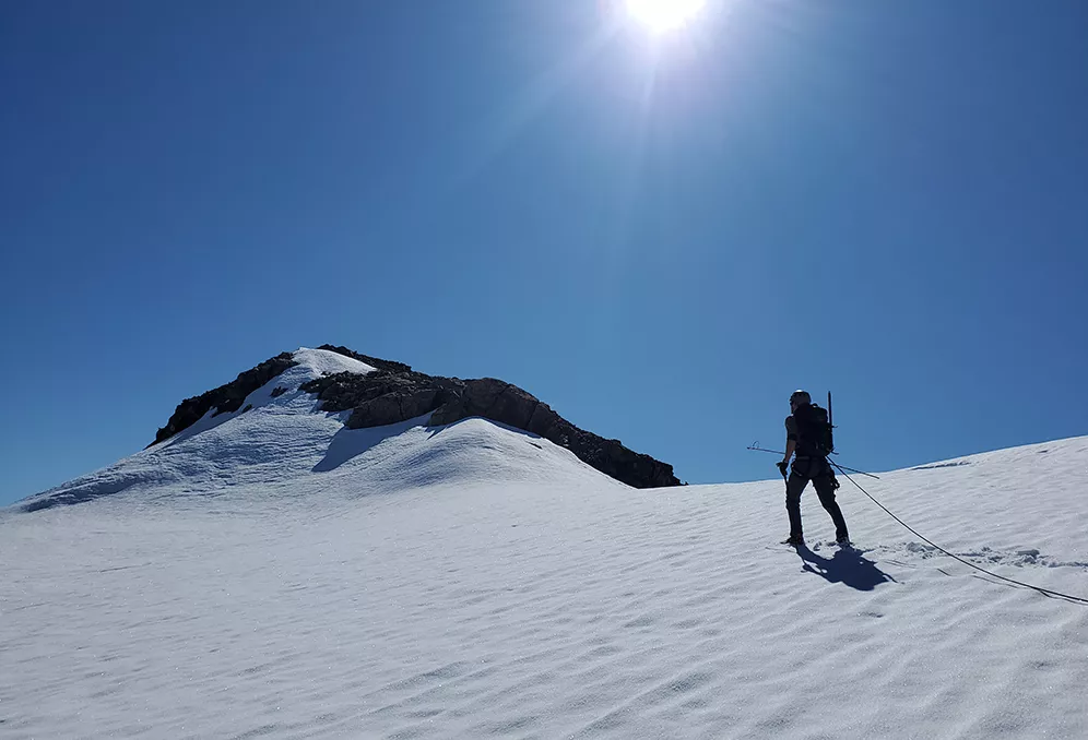 Man scaling an Alaskan peak