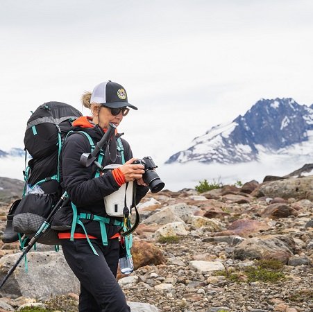 Backpacker checks out her camera in the Alaskan backcountry
