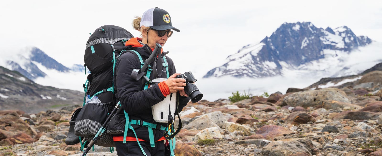Backpacker checks out her camera in Alaska