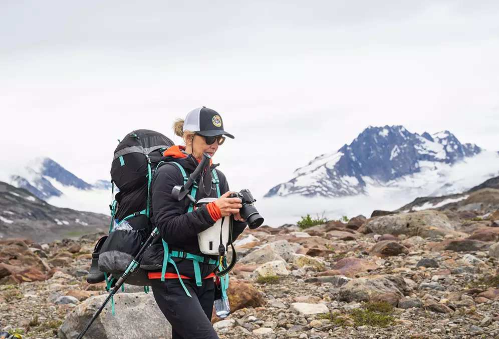 Backpacker checks out her camera in Alaska