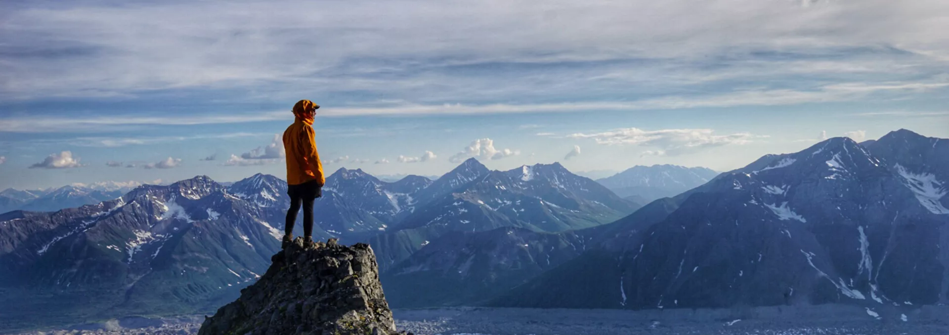 Male Climber Standing On Mountain Summit