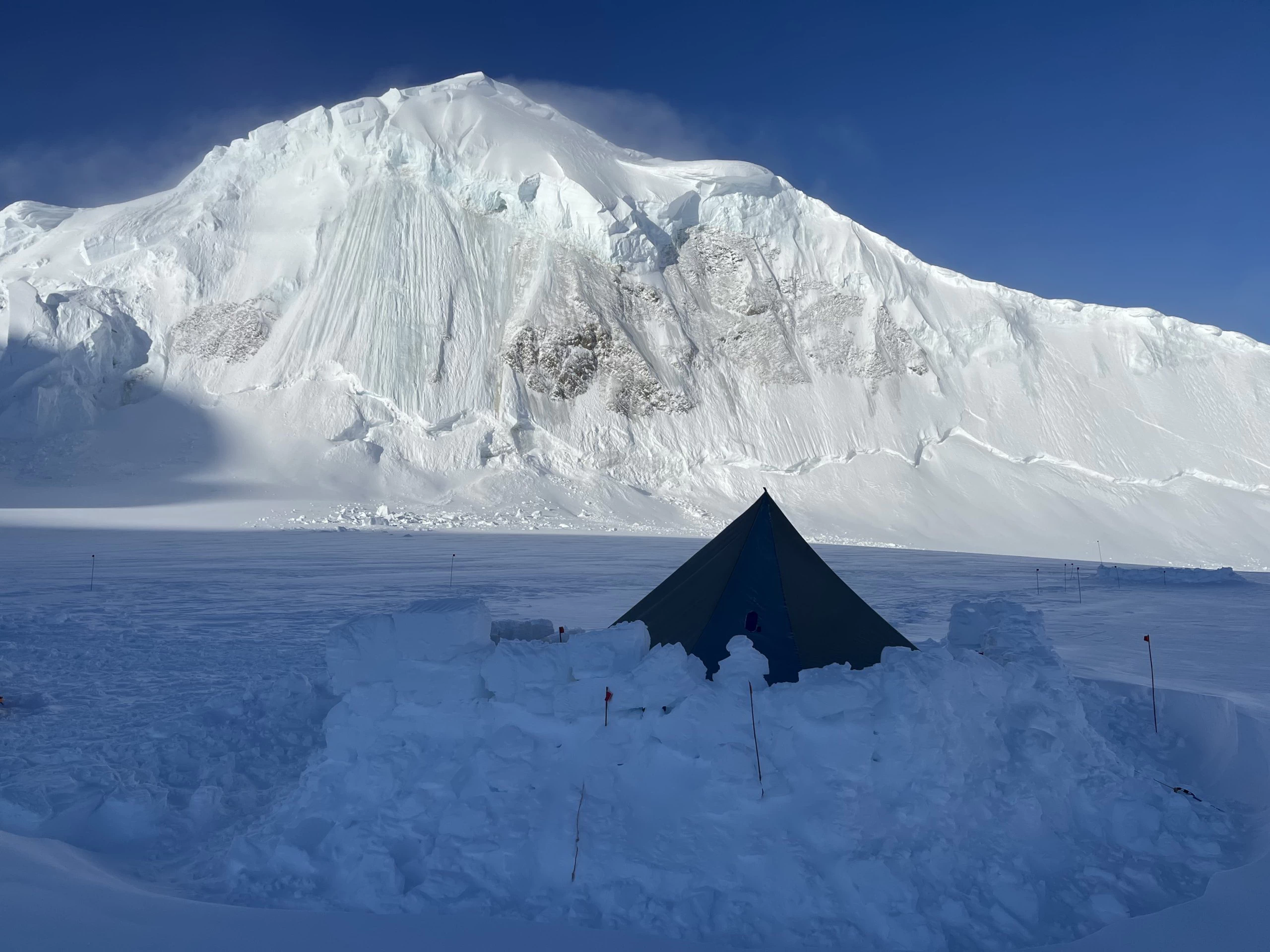 Tent in front of hanging glacier in Alaska