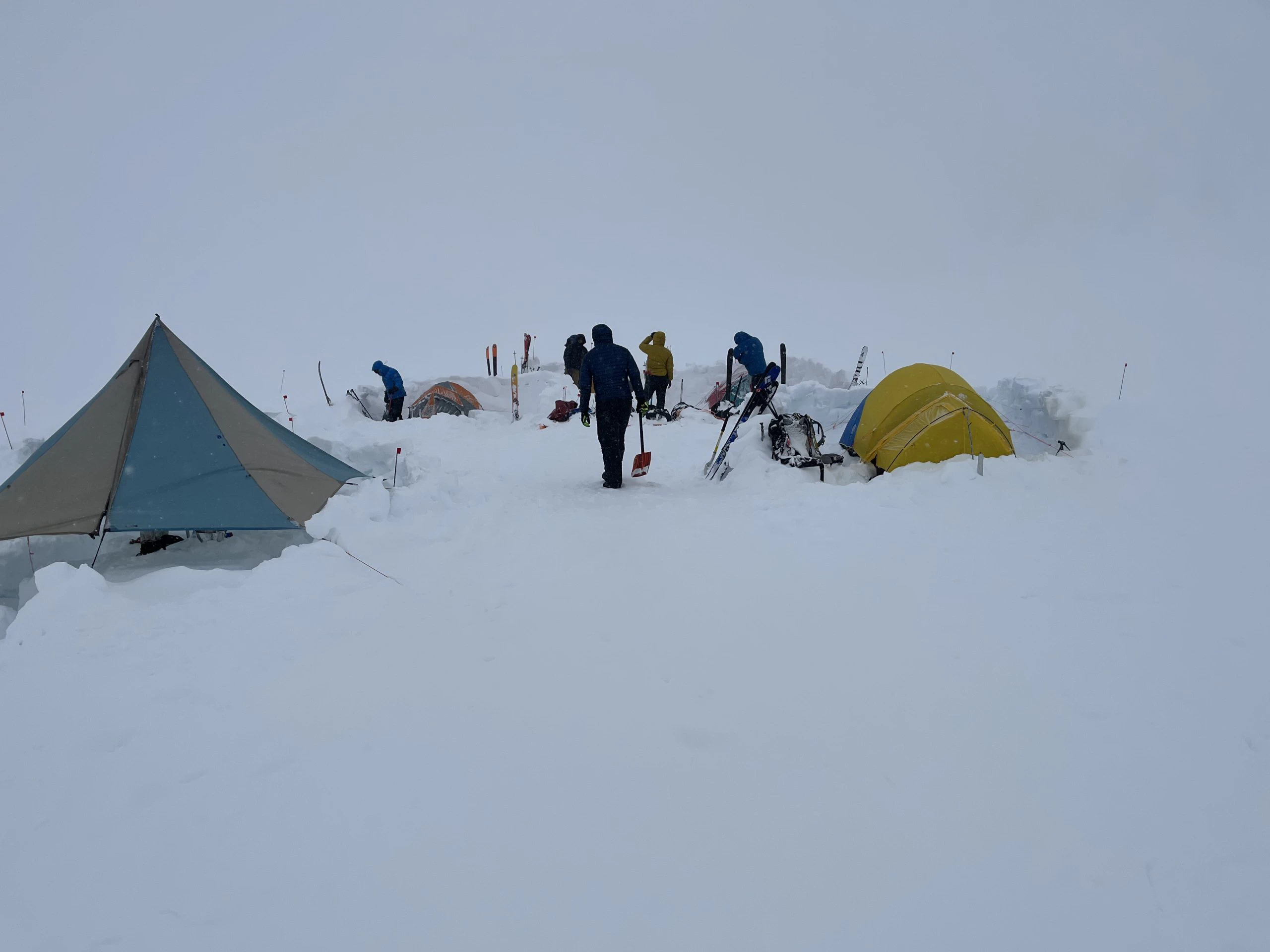 Tents and guides in the snow in a whiteout