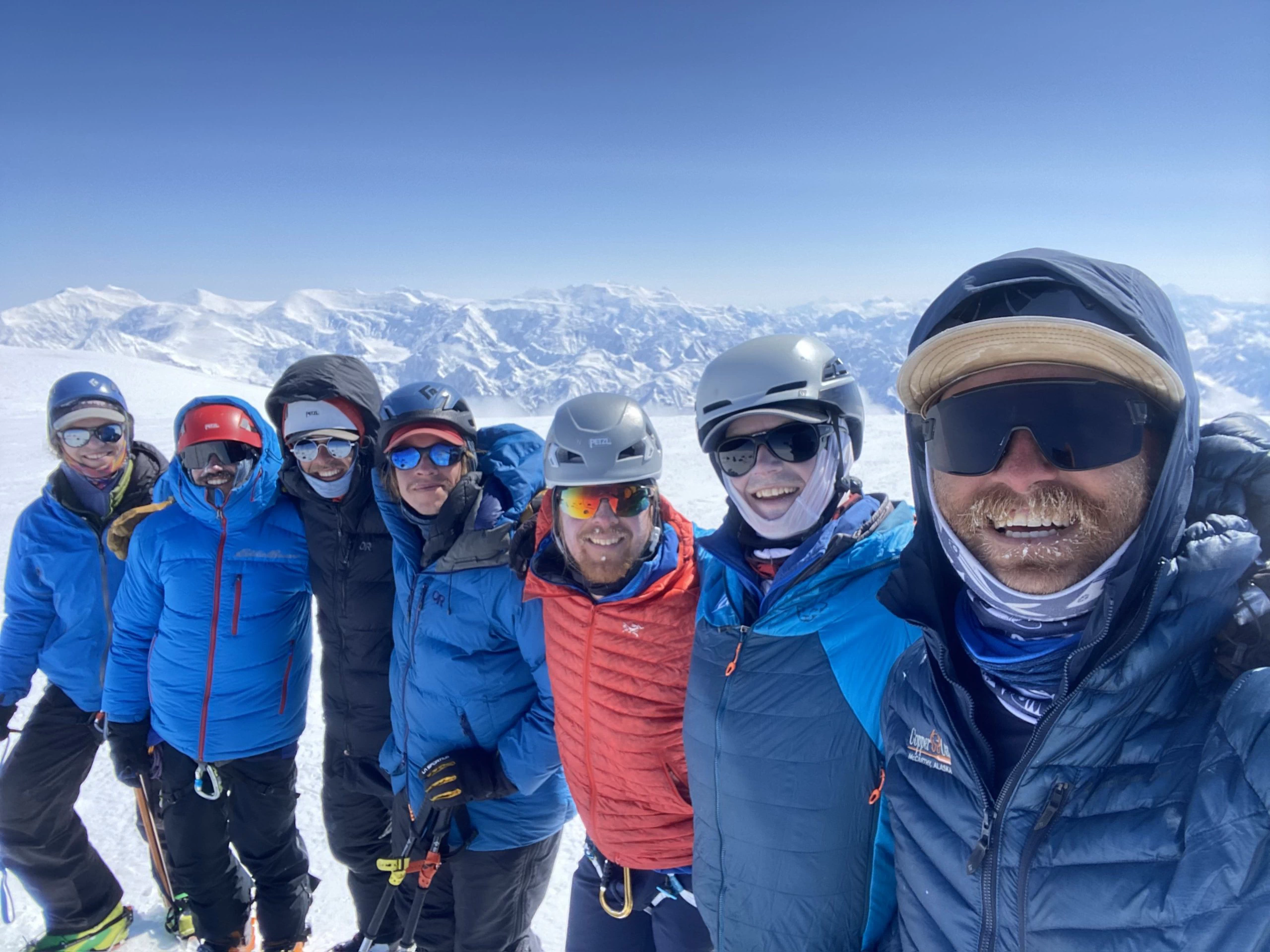 Six guides stand on the summit of Mount Bear in Alaska