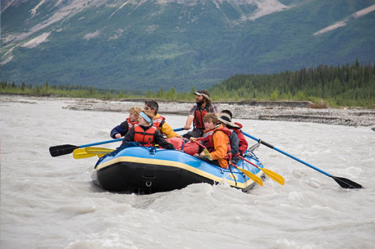 A group of young rafters on a boat