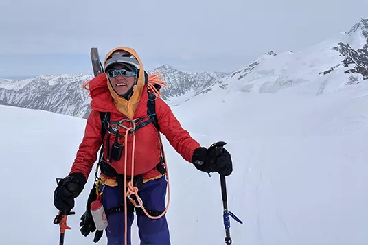 A female backcountry skier is all geared up and ready to cross a glacier
