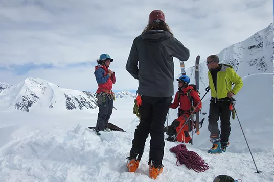 A ski guide preps the group about the descent