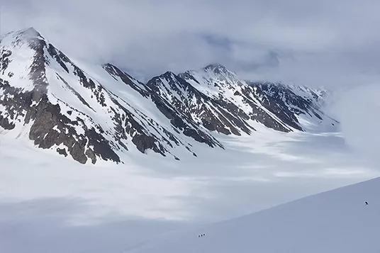 A tiny figure provides scale for an enormous landscape