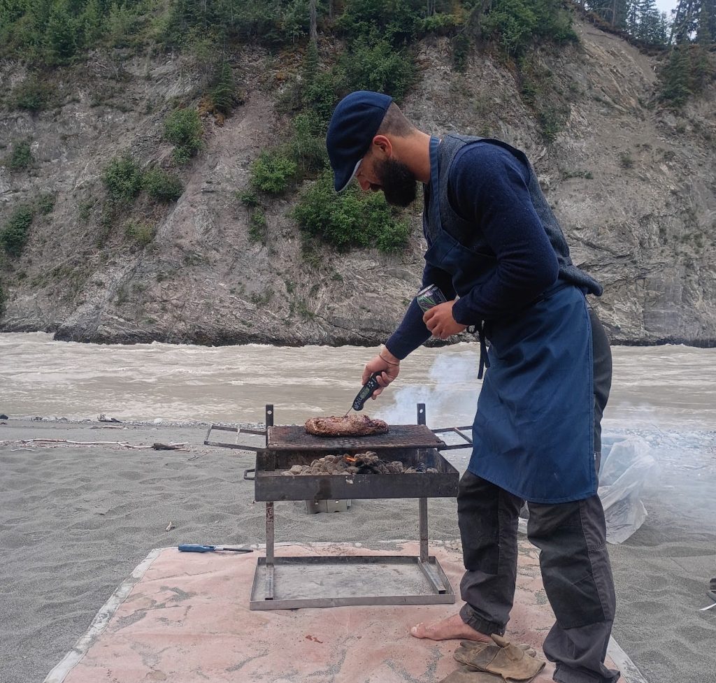 cooking steak on river bar