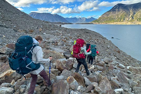 Women backpacking on rugged Alaskan terrain