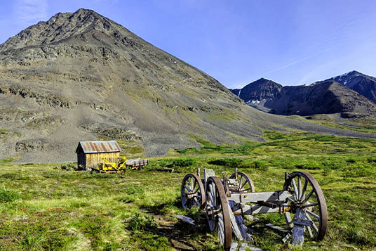 Old equipment and a cabin in the Bremner Historic Mining District