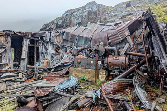 Collapsed and rusty industrial equipment in the mountains