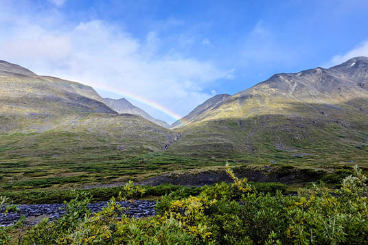 A rainbow spans the mountains in Alaska