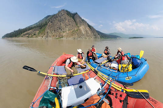 Rafters enjoying a calm float on the milky waters of the Yukon River