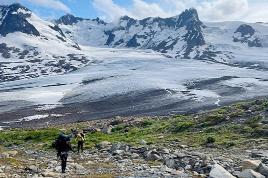 Backpackers move uphill in the Wrangells backcountry