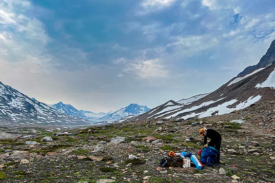 A backpacker takes a break in the Alaskan backcountry