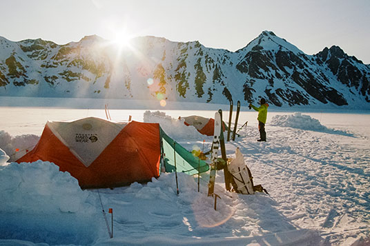 Sun setting on a backcountry ski base camp in Wrangell - St. Elias National Park