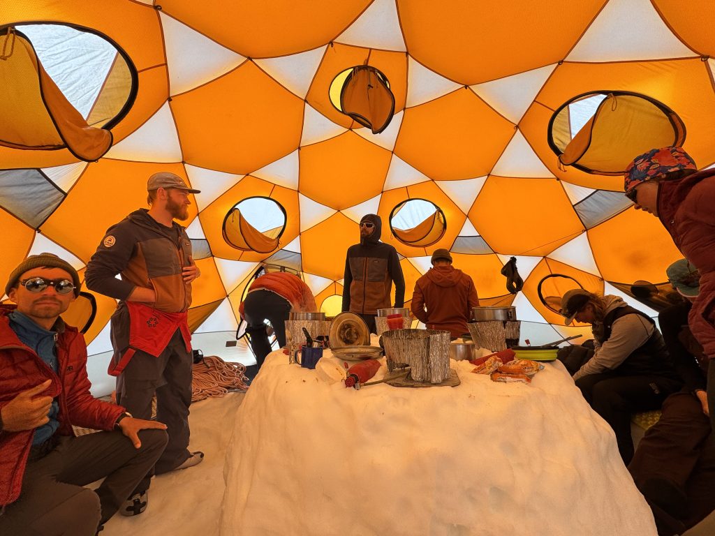 Guides spread out in a big tent with a snowy table in the center