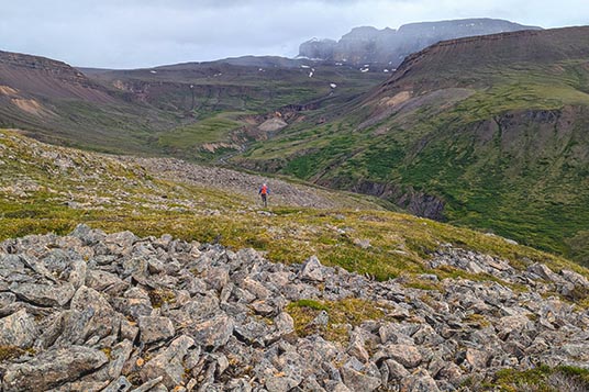 A tiny backpacker in a huge Alaskan backcountry landscape
