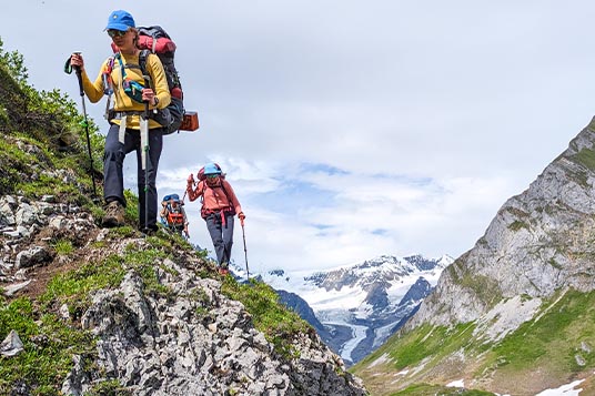 Backpackers traverse a band of rocks in Alaska