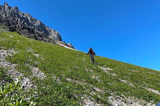 A hiker on a steep sidehill
