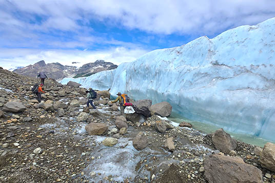 Backpackers cross glacial moraine in Alaska