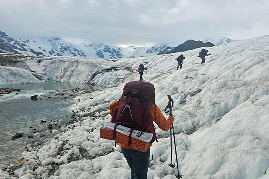 Backpackers on uneven glacial terrain