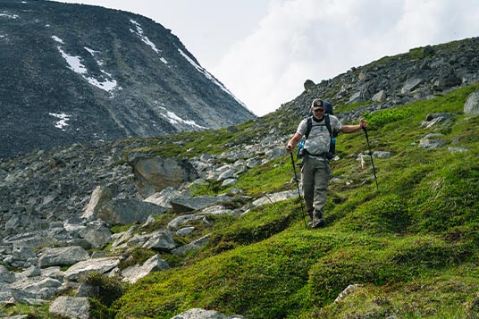 A backpacker traverses challenging terrain in Wrangell - St. Elias