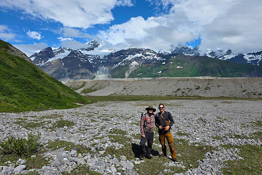 Two hikers on rocky terrain in Alaska