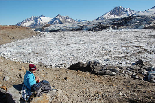 A child eats lunch at a glacial lake