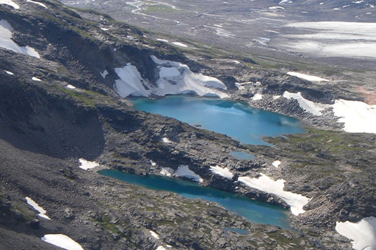 Two blue alpine lakes seen from above