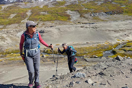 Two female hikers moving uphill