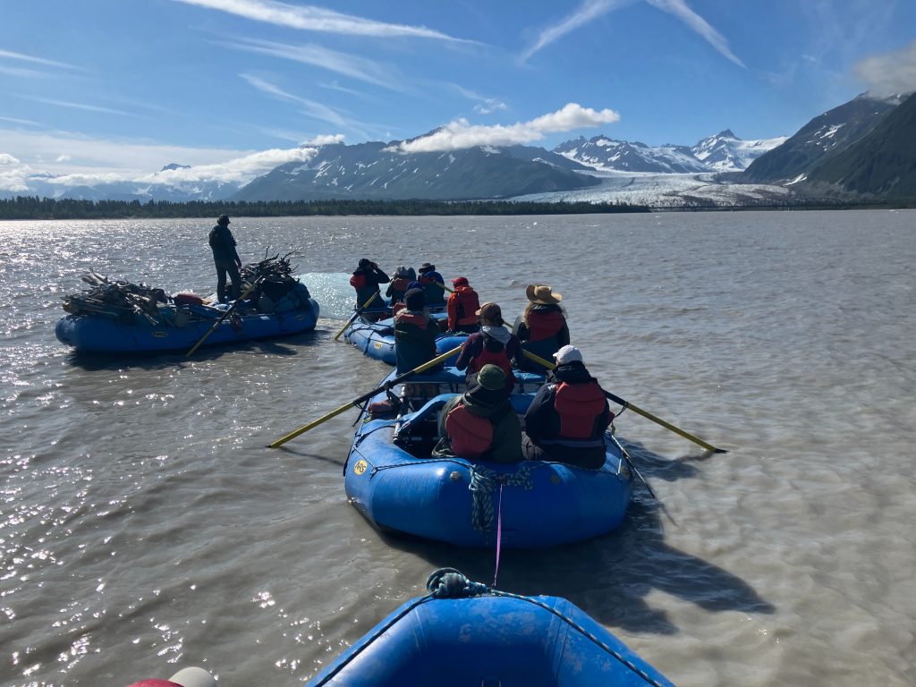 NRS rafts tied together full of raft guides and clients attached to an iceberg